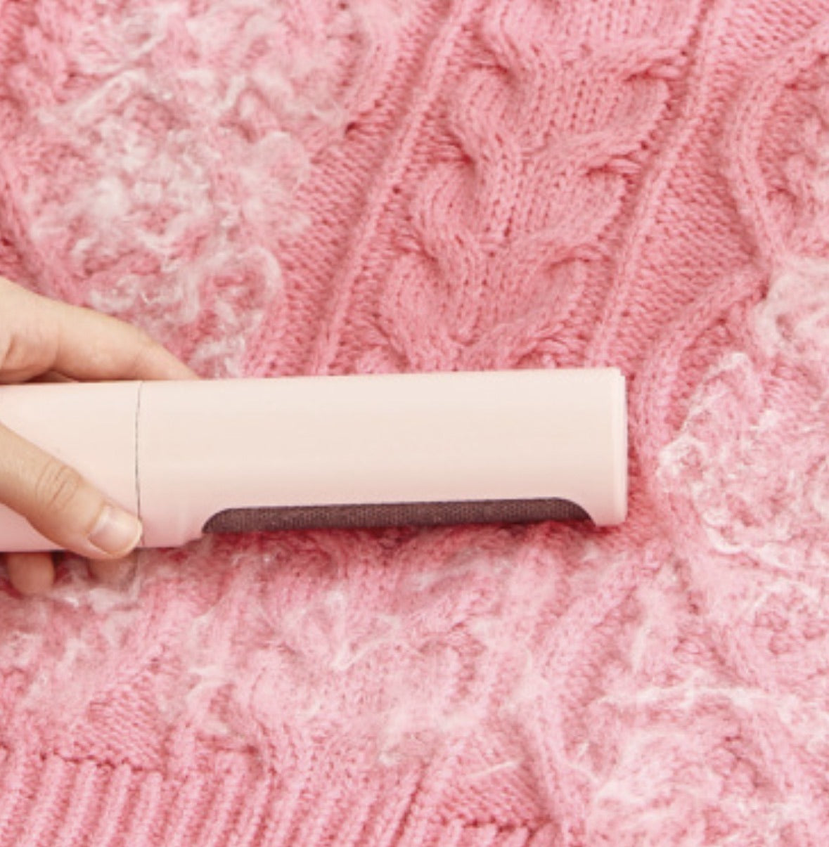 ShedSmart remover pulling lint and fuzz off a knit sweater